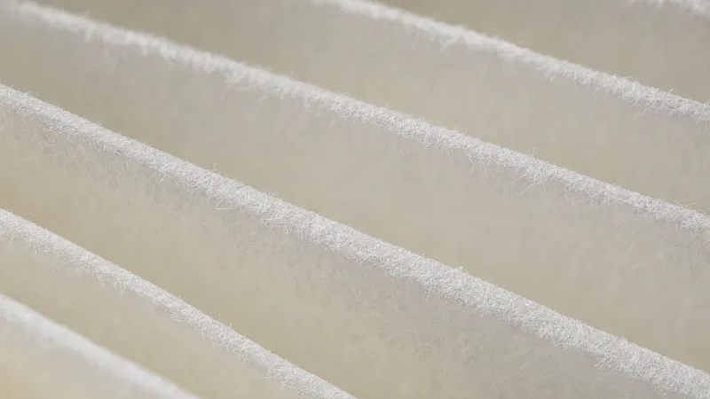 Close-up of white pleated cabin filter media in side light